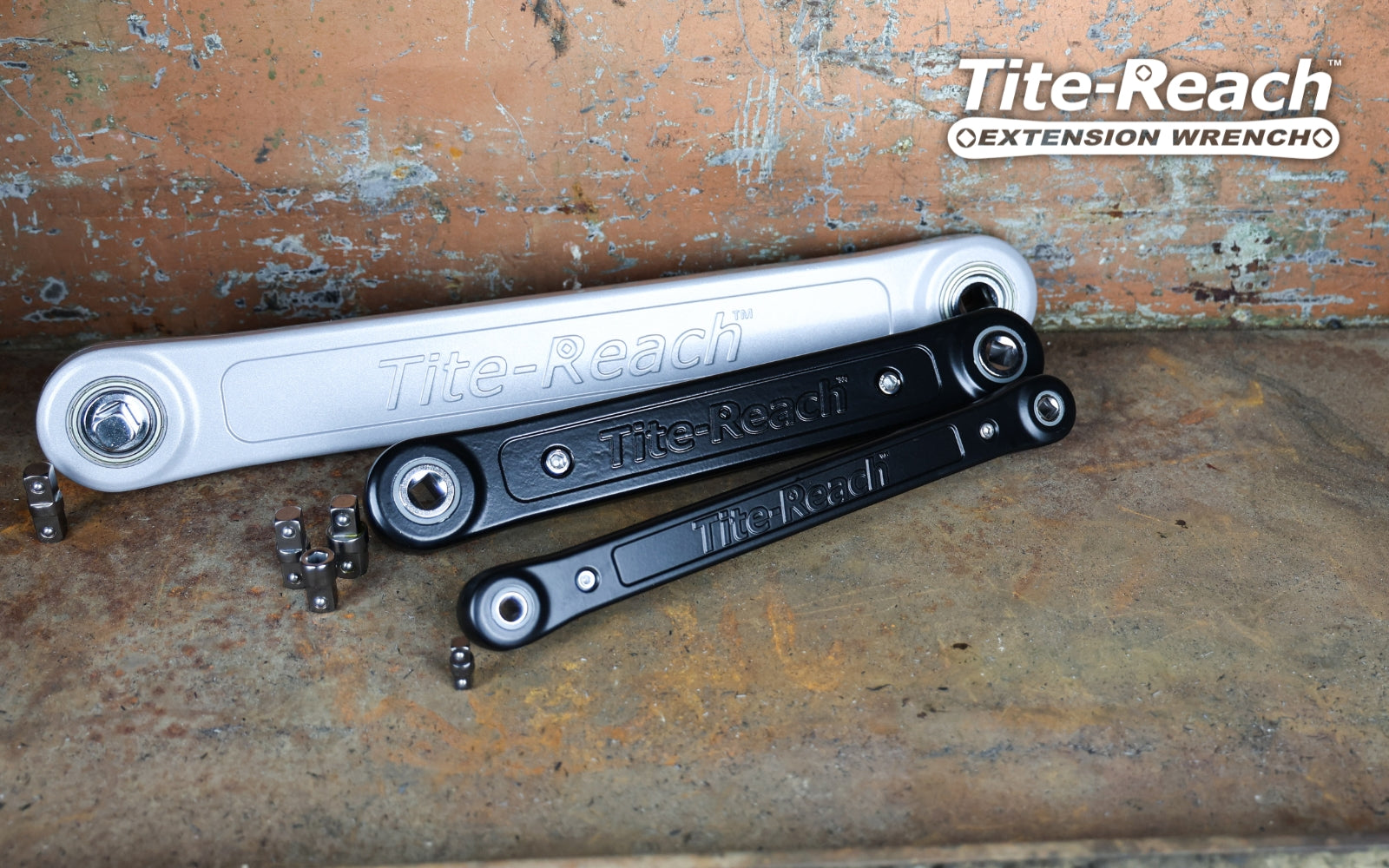 Tite-Reach extension wrenches on a rusty metal surface