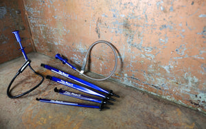 Six Extension Clamps on a rusty surface.