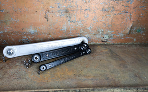 Three Extension wrenches on a rusty metal surface